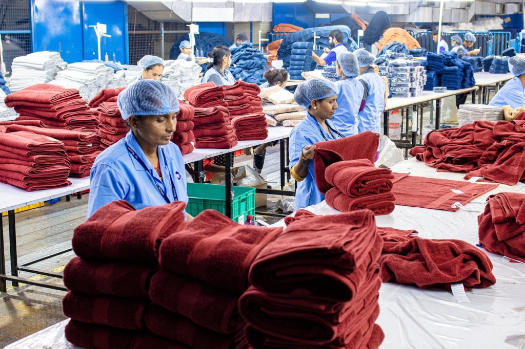 pexels photo 31030914 Workers in an Indian factory fold towels efficiently. Textile industry scene.